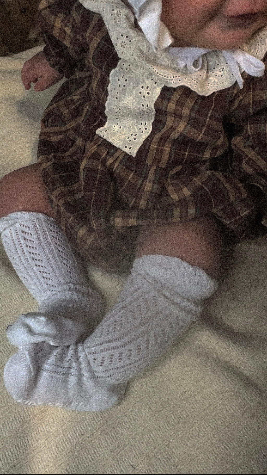 Baby wearing 100% cotton girls vintage Brownish plaid bubble romper with lace front and collar. 