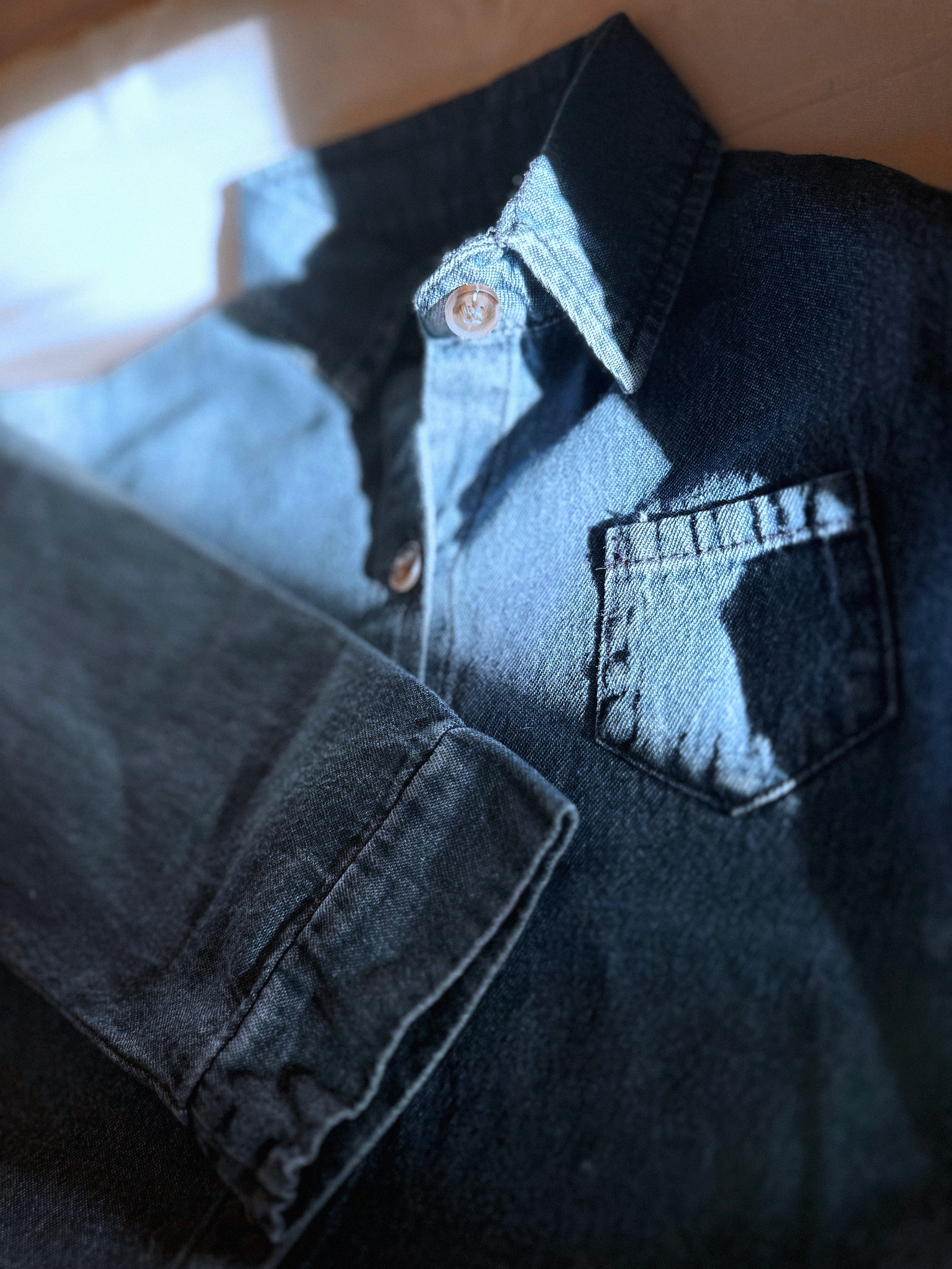 Light ti medium wash 100% cotton denim shirt, long sleeve, collar, buttons. 