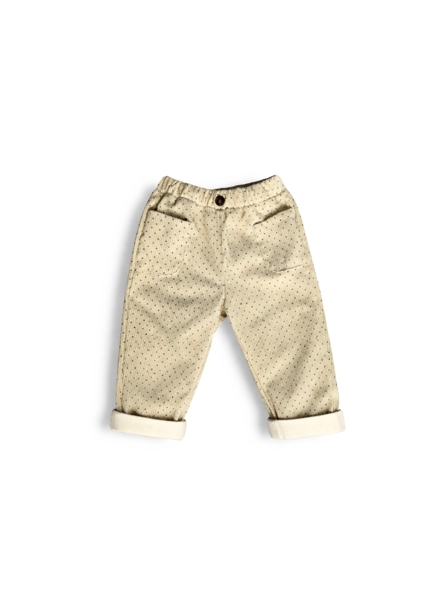 Beige and black polka dot corduroy pants on a white background