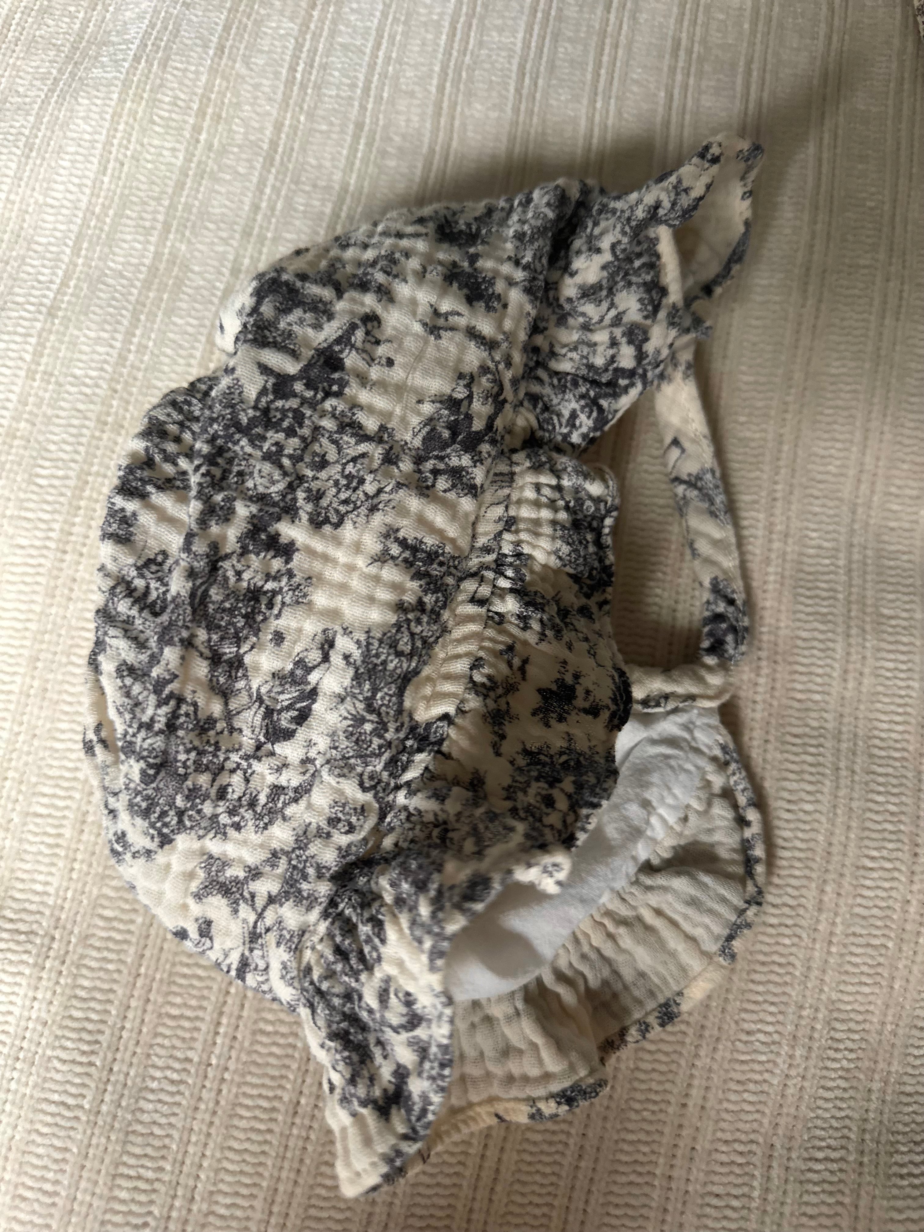 Floral-patterned matching bonnet on a textured surface