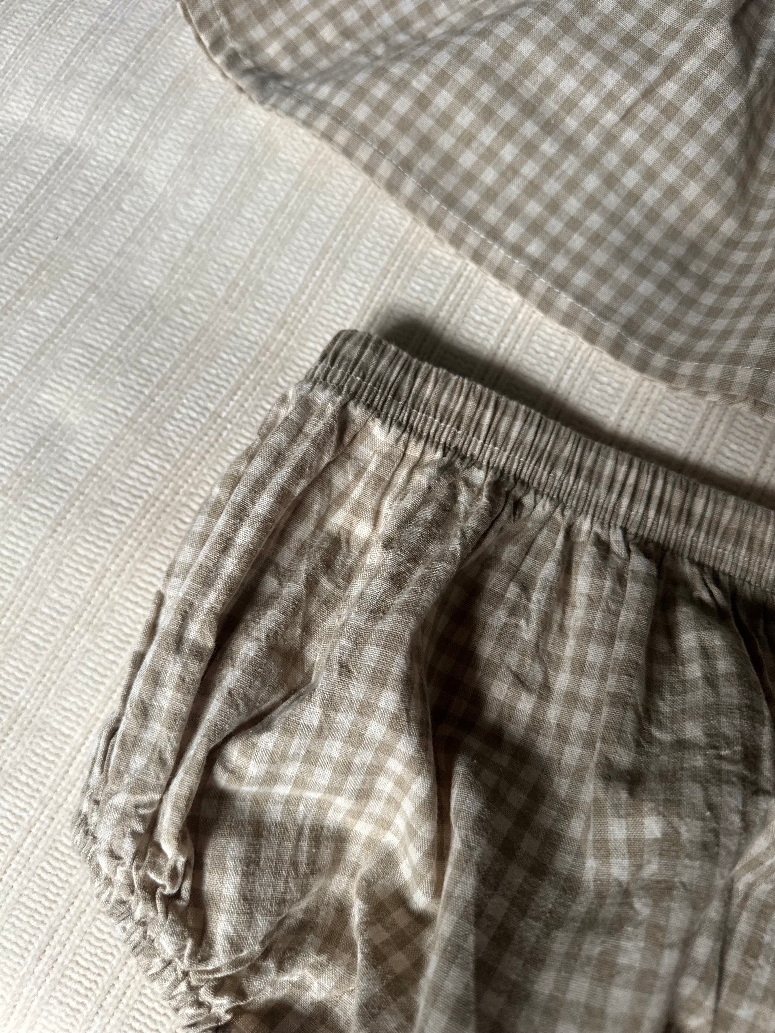 Close-up of bottom part of set of gingham girls set with a textured surface background
