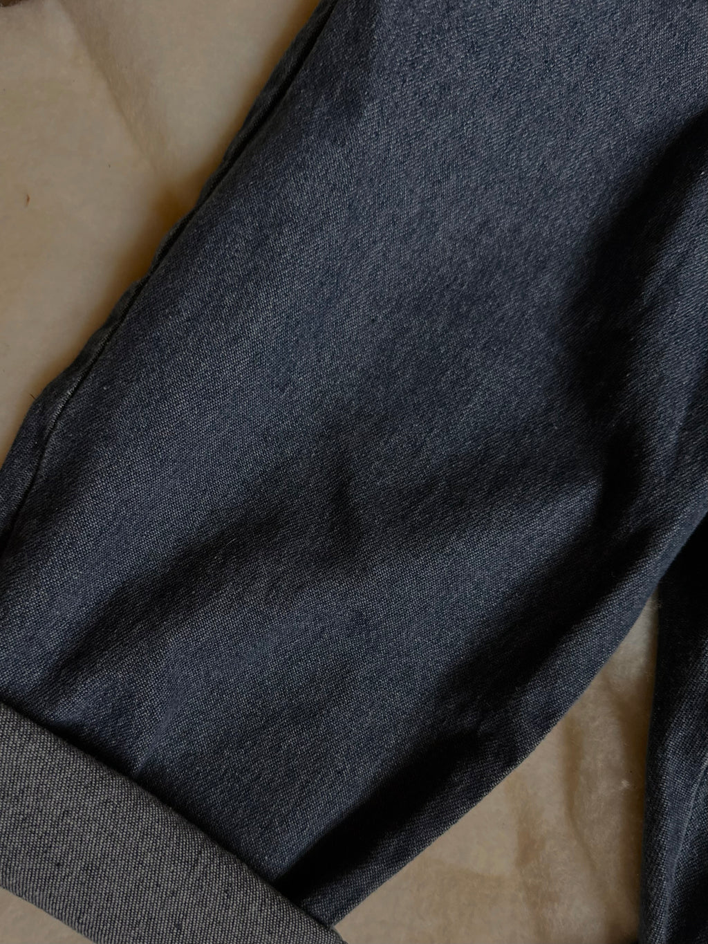 100% cotton medium to dark wash denim jeans cuffed. 