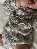 Close-up of a baby's blue gray floral-patterned romper