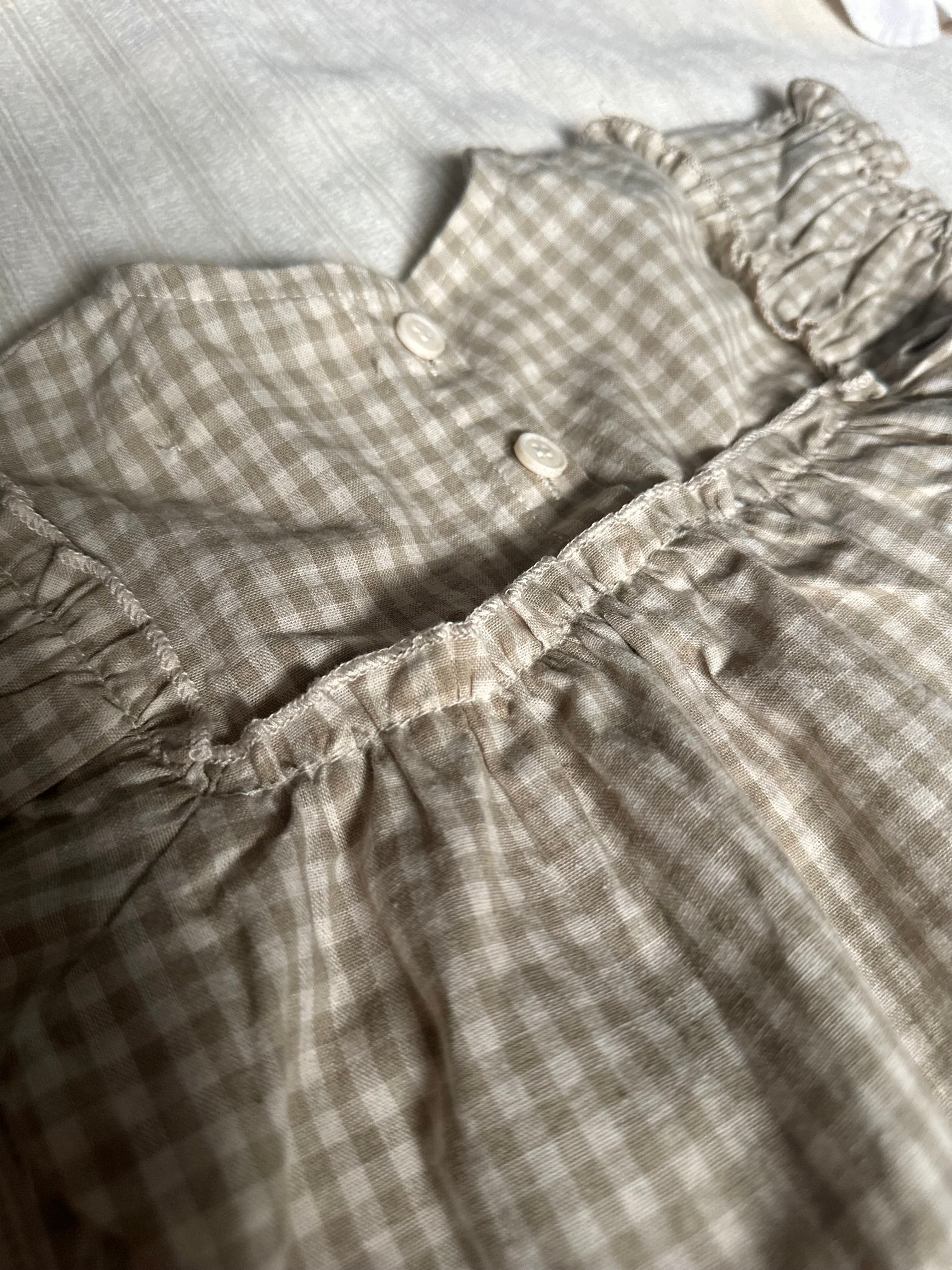 Close up details of 100% cotton tan colored gingham baby set top, back with buttons 