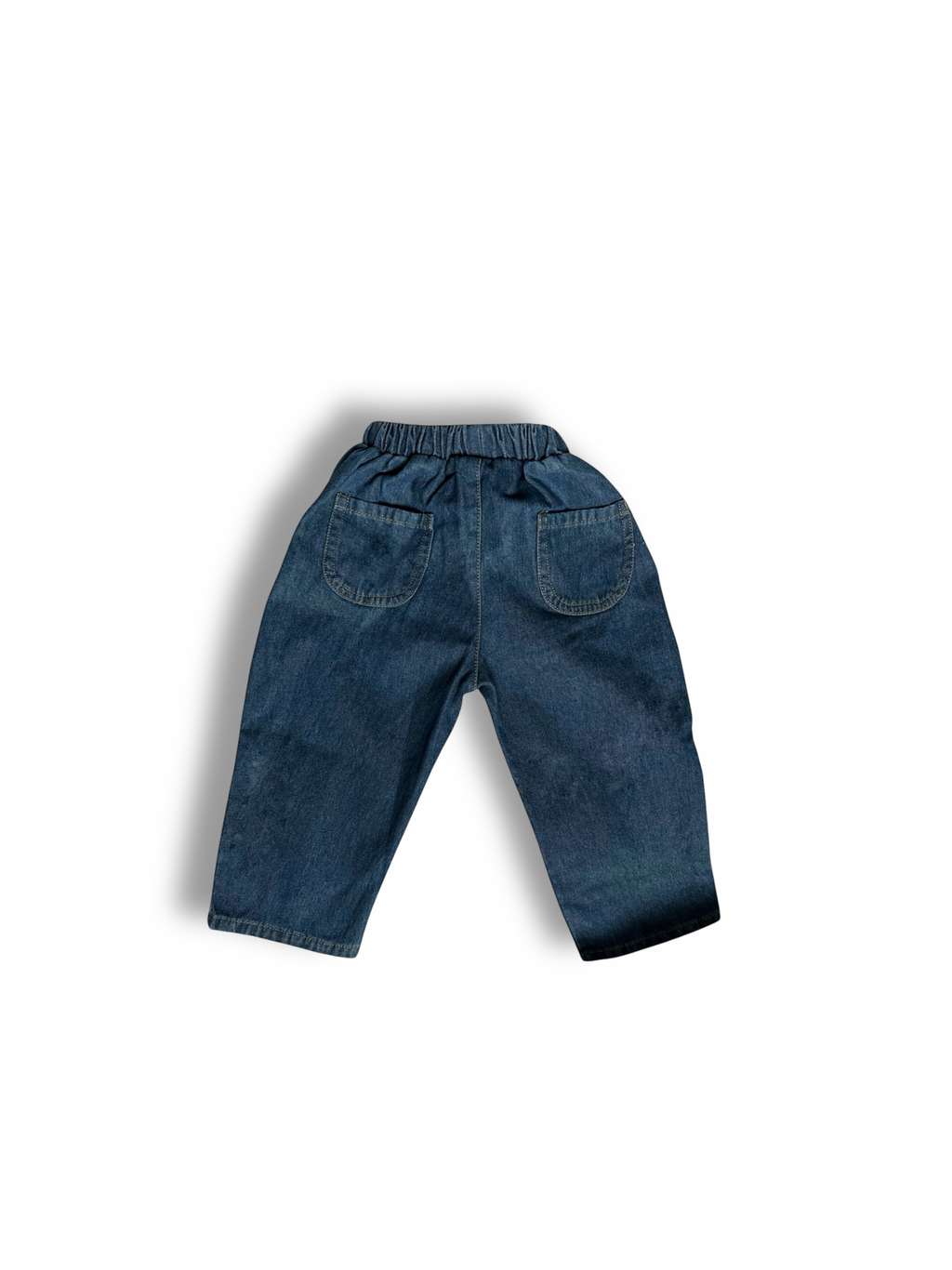 Back of 100% cotton medium to dark wash denim jeans. 